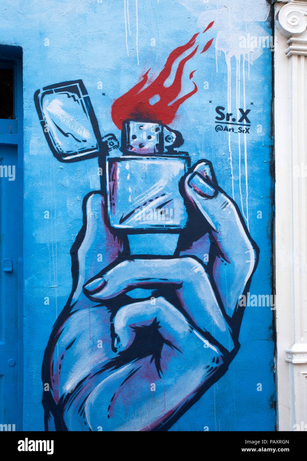 Detail of graffiti of a hand holding a lighter in blue tones Stock