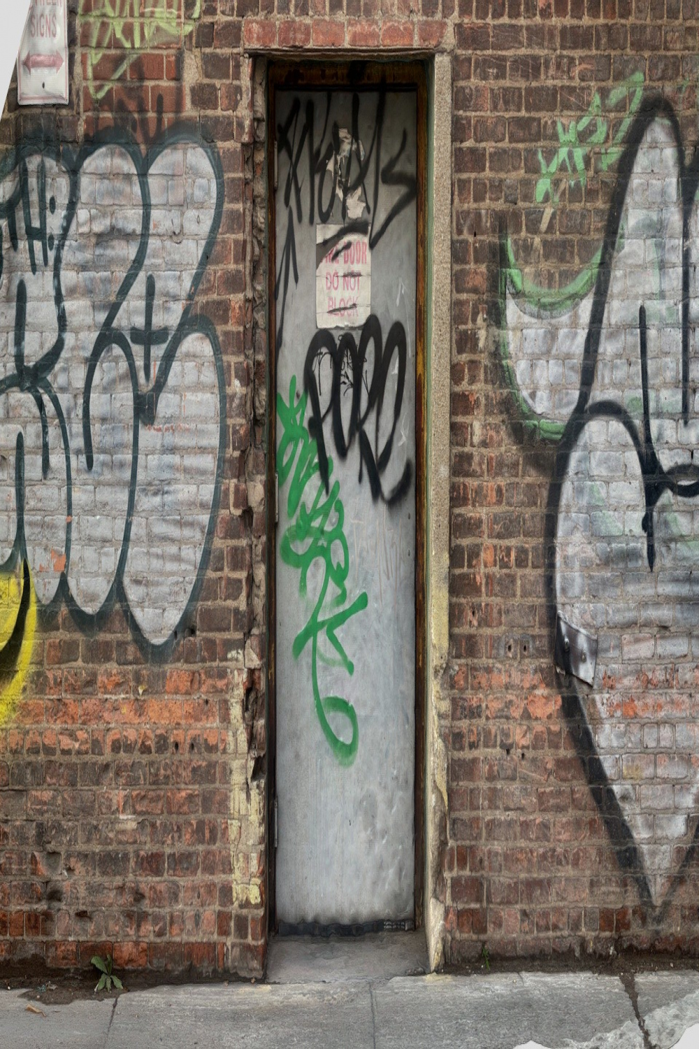 Industrial graffiti door with brick wall - Buy Royalty Free D