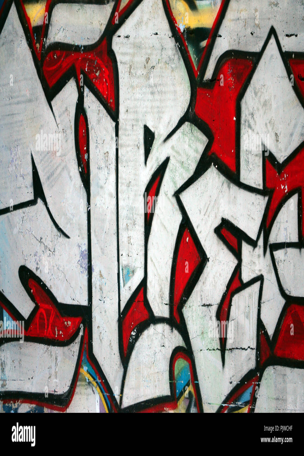 The old wall, painted in color graffiti drawing red aerosol paints