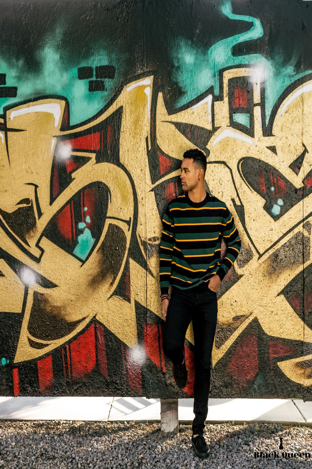 Black male model posing by wall graffiti  Graffiti photography