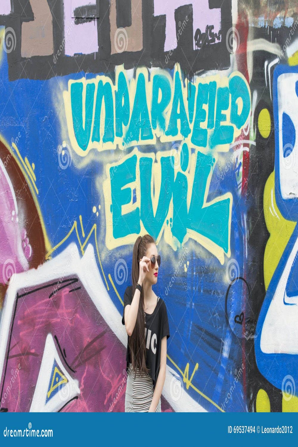 Portrait of Fashion Young Woman on Graffiti Background