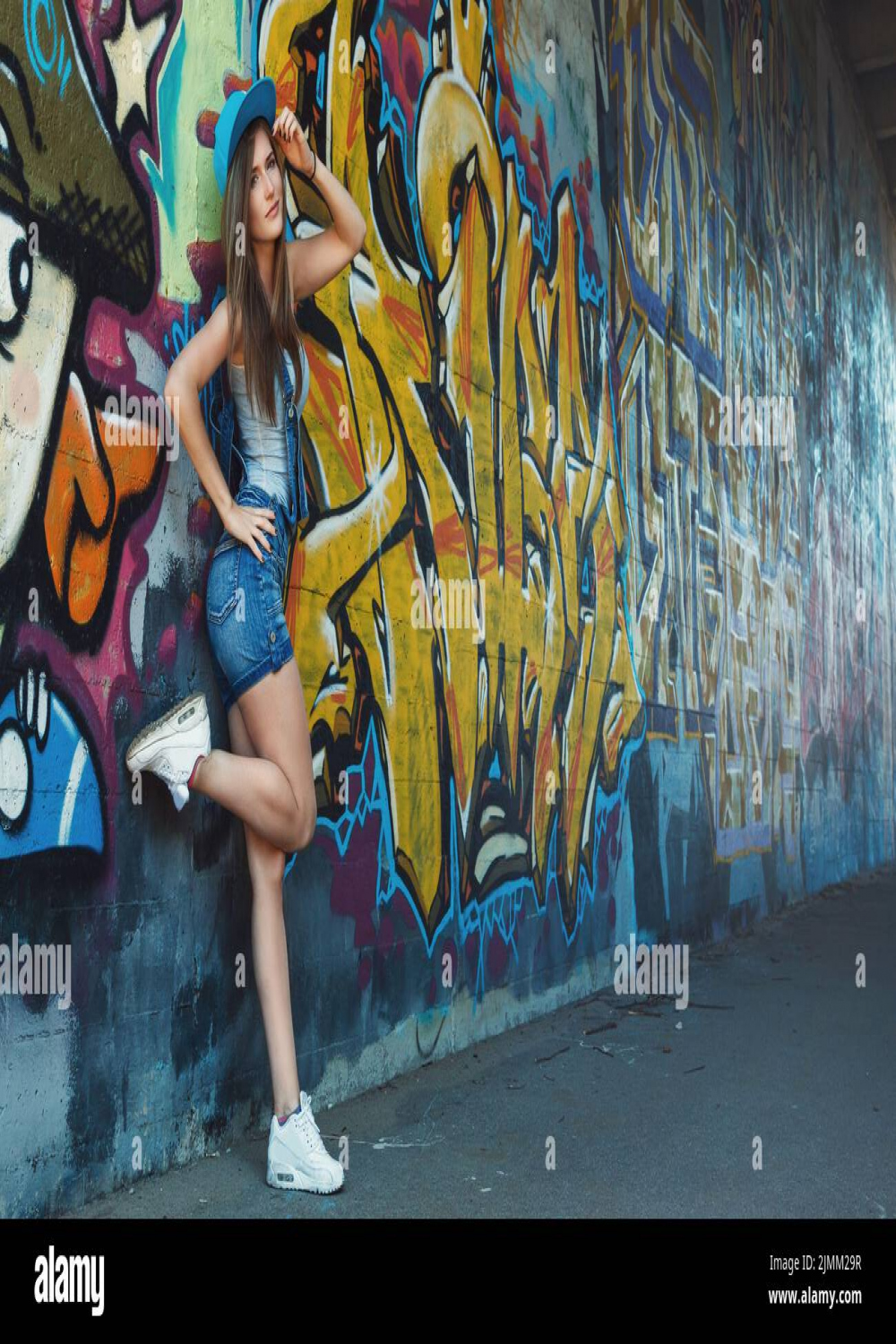 Posing against graffiti wall hi-res stock photography and images